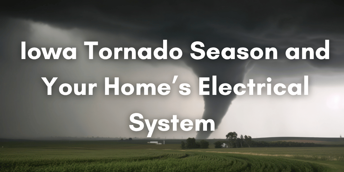 A large tornado touches down over rural Iowa farmland beneath dark storm clouds, with bold white text reading ‘Iowa Tornado Season and Your Home’s Electrical System.’