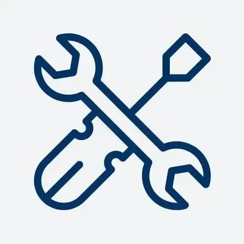 A flat head screwdriver and a wrench crossing over it forming an x