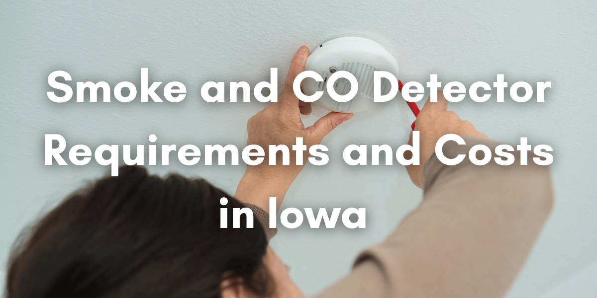 Person installing a ceiling-mounted smoke and carbon monoxide detector beneath the text “Smoke and CO Detector Requirements and Costs in Iowa.”